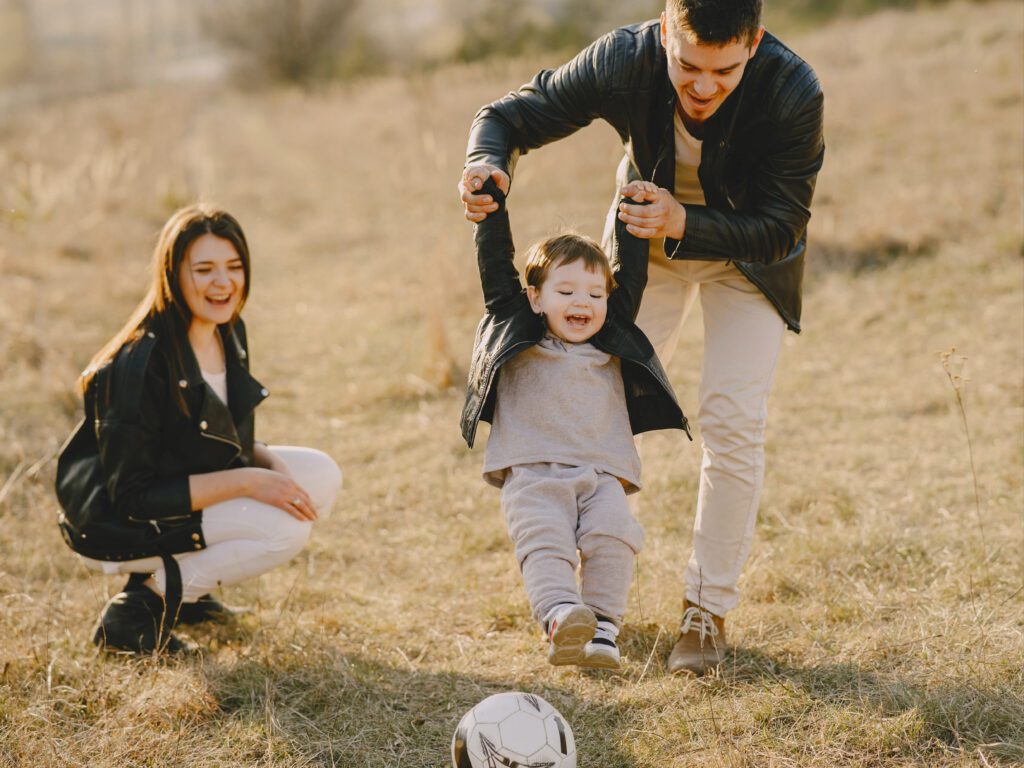 photo of family having fun with soccer ball